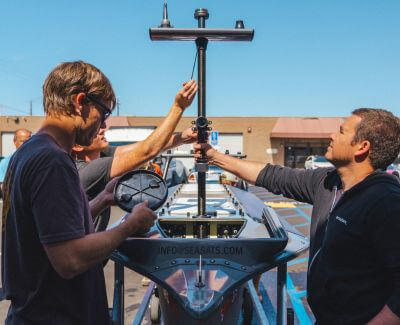 The Seasats team secures a 3D printed antenna to the bow of the Lightfish ASV