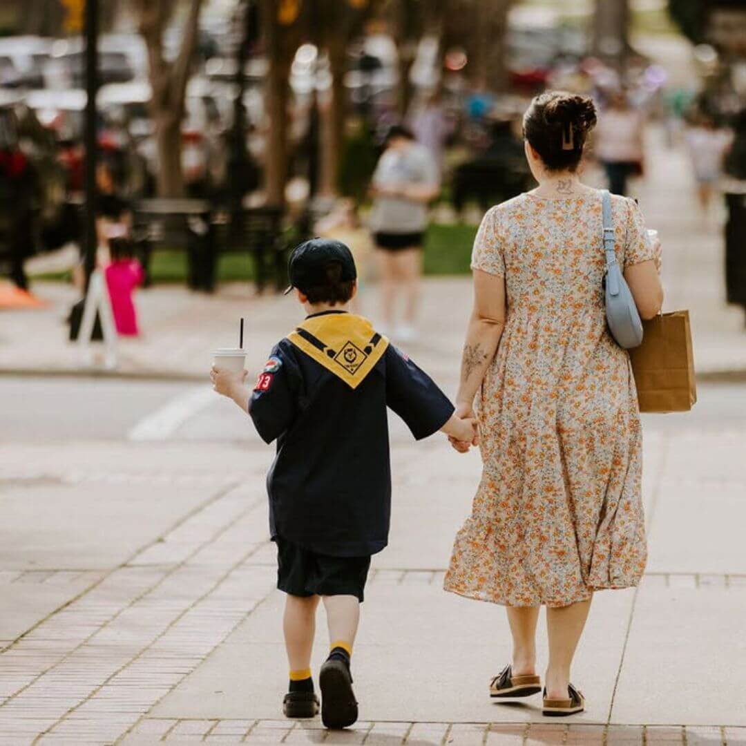 Parent and child walking through downtown Statesville, North Carolina