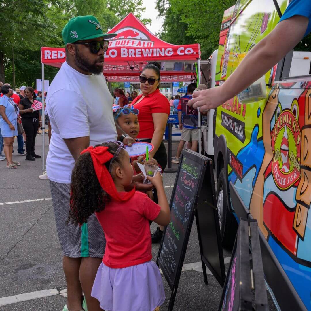 Family enjoying treats from a local food truck at a community event in Statesville, North Carolina
